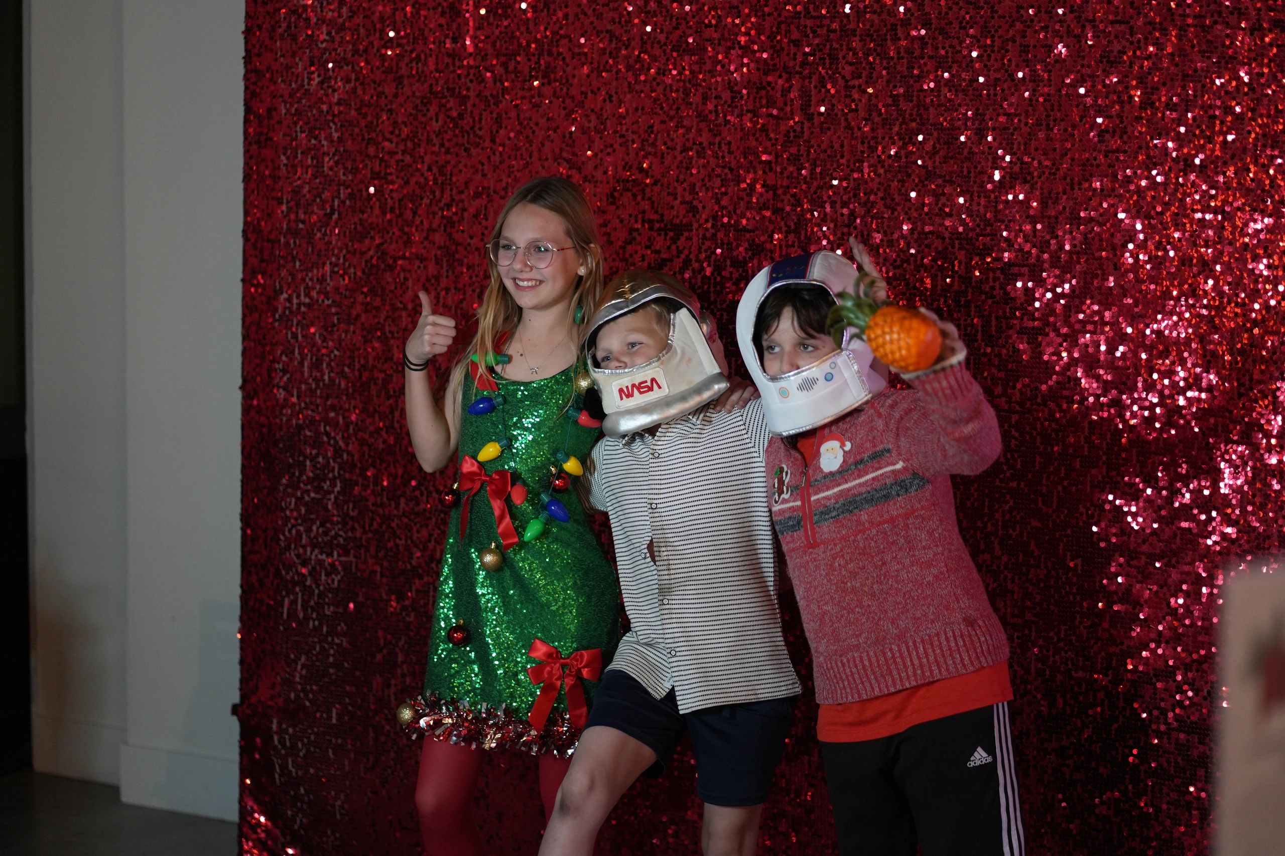 Children in festive costumes at the Festival of Trees holiday photo booth